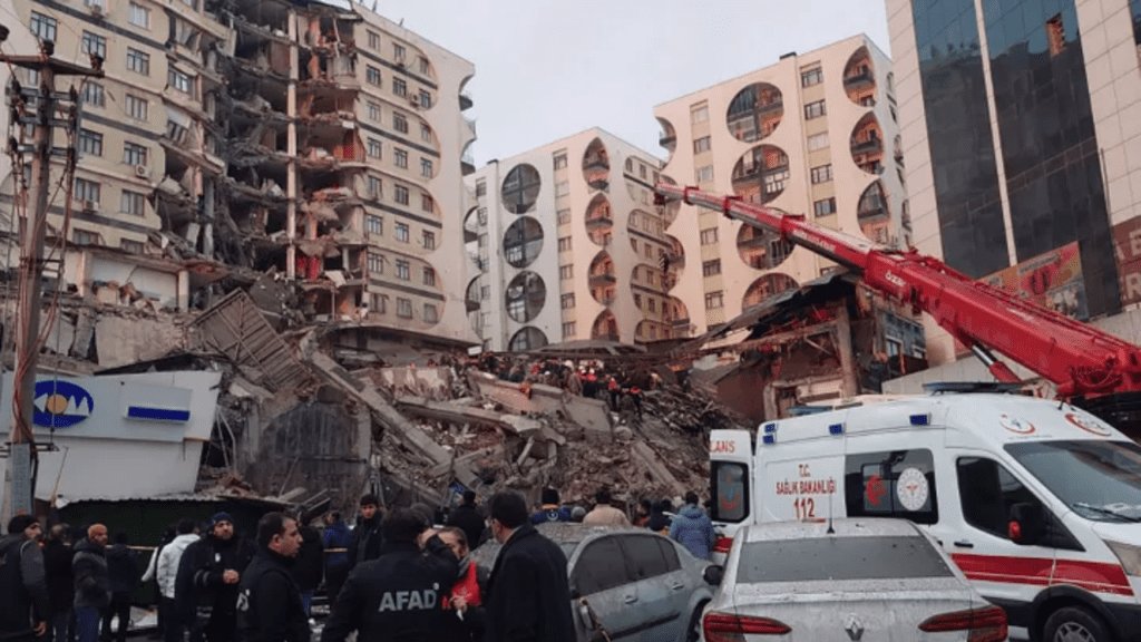 After an earthquake in Diyarbakir, Turkey, early on Monday, Feb. 6, 2023, rescue workers and medical teams try to reach people who are stuck in a building that has collapsed.
