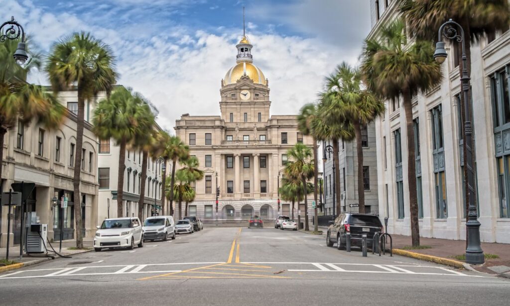 Historic Savannah, GA with oak trees, Spanish moss, and charming architecture.