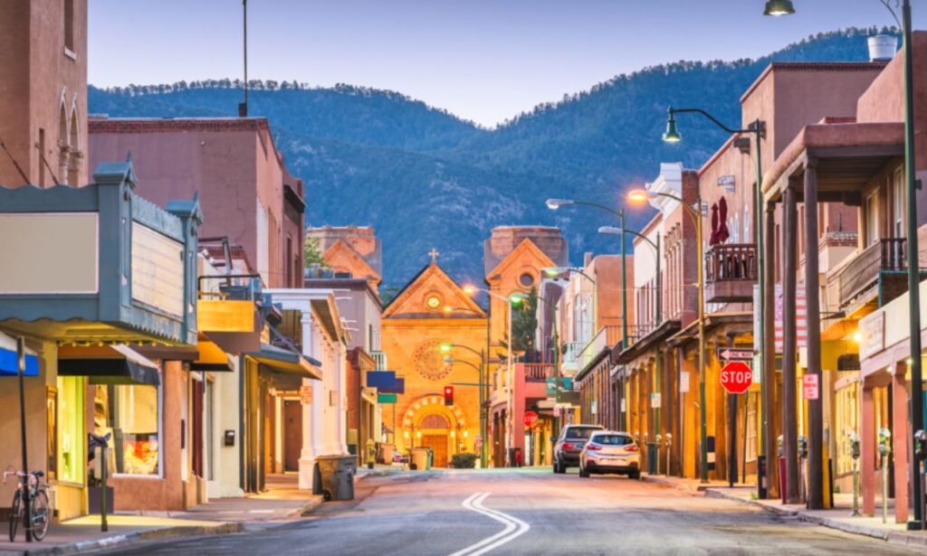Santa Fe New Mexico desert landscape with adobe architecture and mountain backdrop.