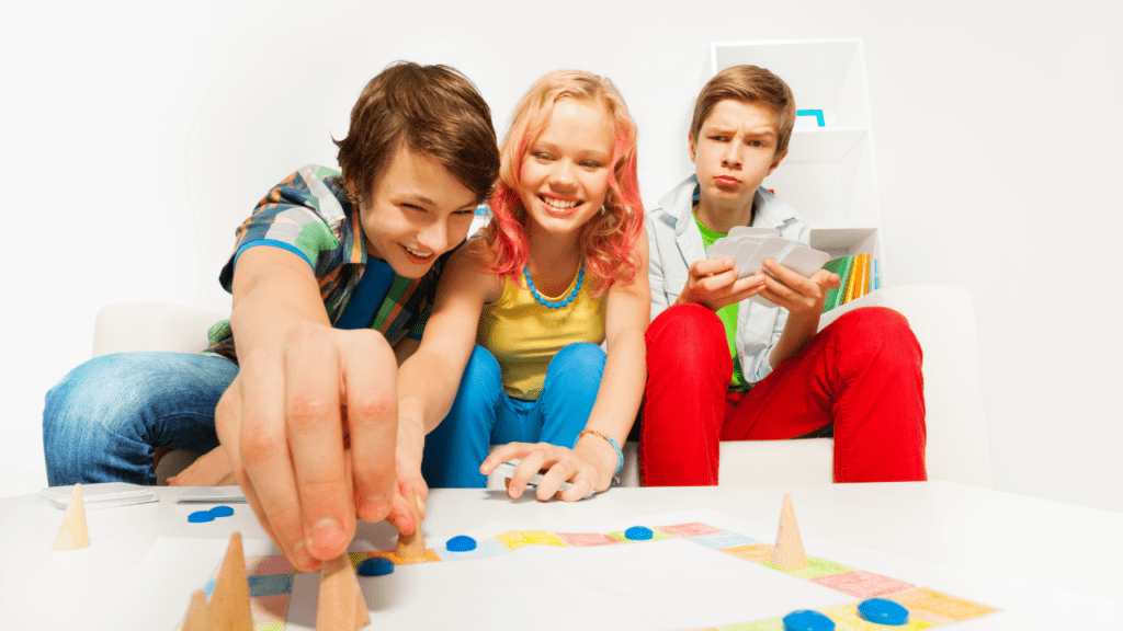 People gathered around a table enthusiastically playing a colorful board game.