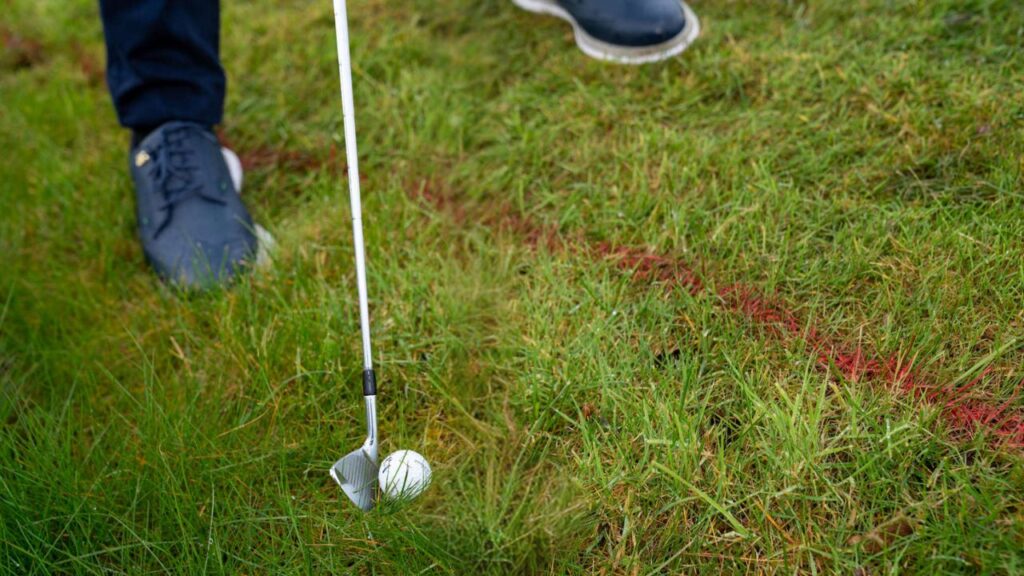 In a hole, you will still lose points if you touch the sand in front of or behind your ball. 
