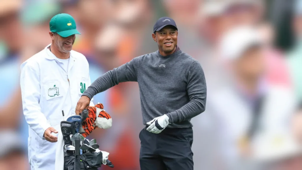 During a practice round before the 2024 Masters, Tiger Woods and his helper Lance Bennett pick out a club.
