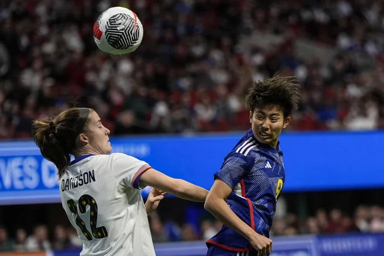 Saturday, April 6, 2024, in Atlanta, the first half of the SheBelieves Cup women's soccer event. Riko Ueki (9) of Japan heads the ball while Tierna Davidson (12) of the United States defends. 

