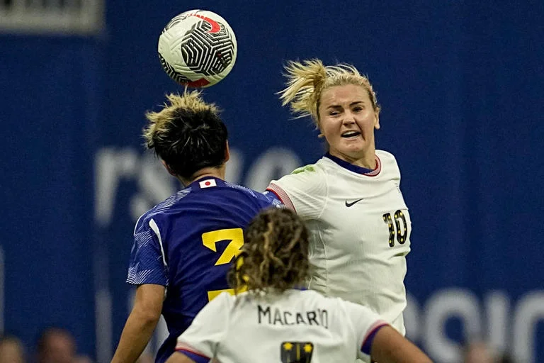 A SheBelieves Cup women's soccer game is being played in Atlanta on April 6, 2024. During the second half, Lindsey Horan (10) of the United States and Moeka Minami (3) of Japan go up for a head ball. The US won by a score of 2-1.
