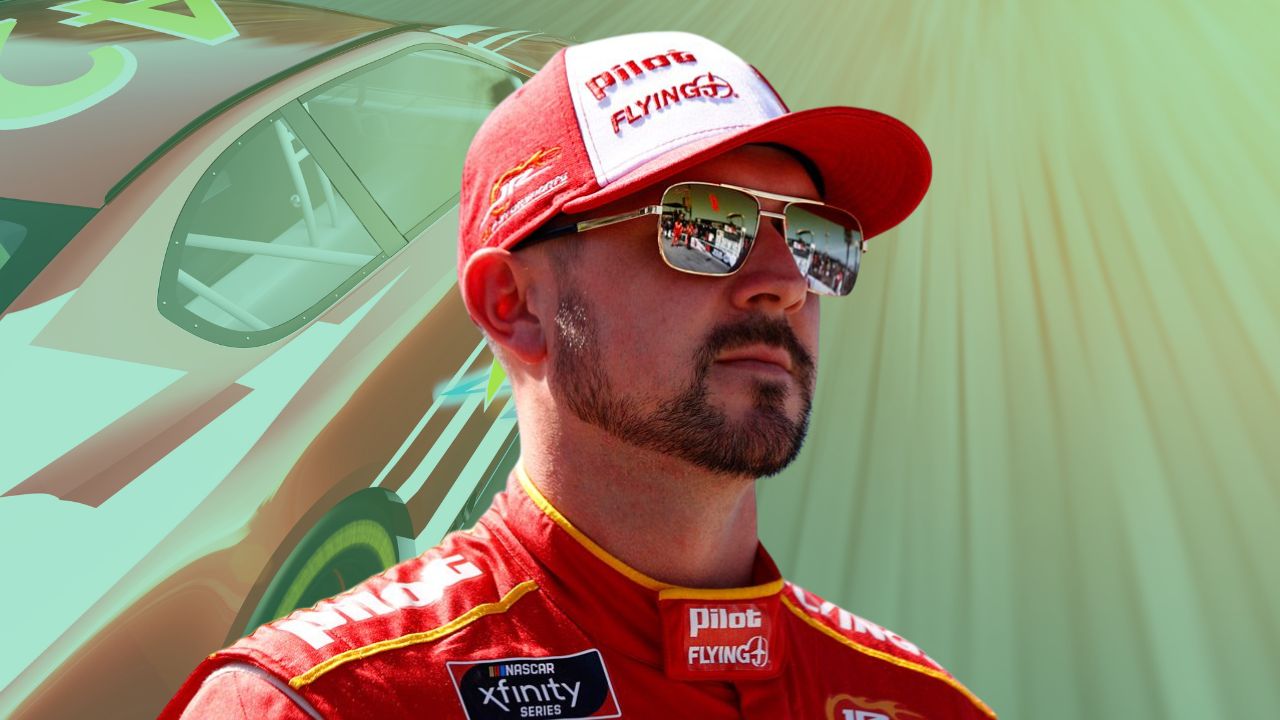Michael Annett standing beside his NASCAR race car during a pre-race event.