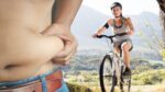 A person cycling on a scenic road, symbolizing fat loss and fitness through cycling.