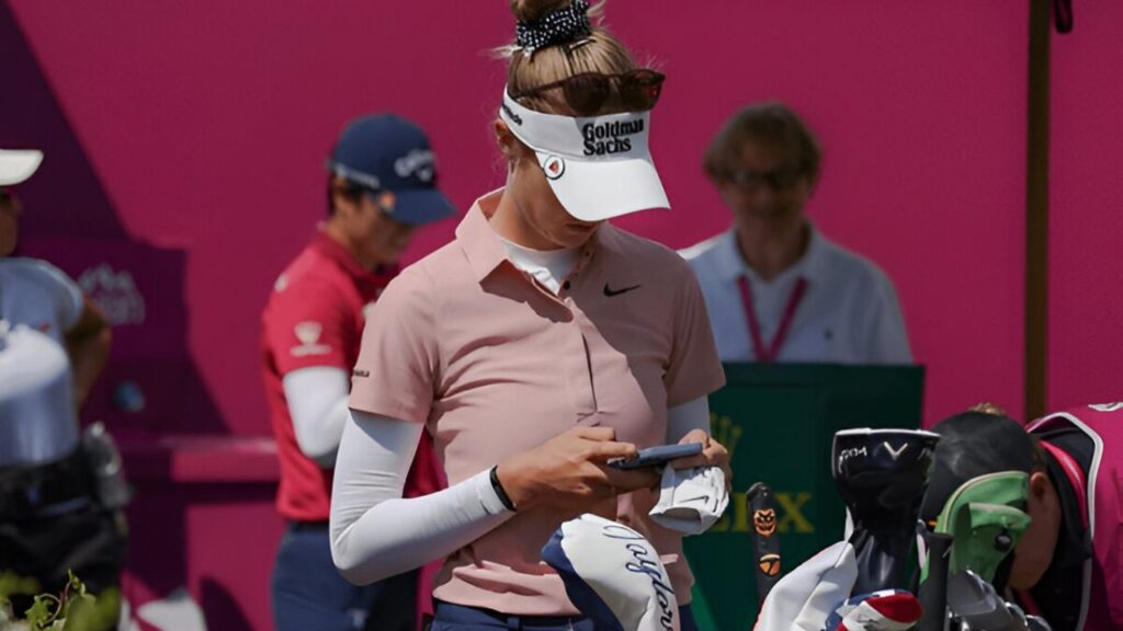 Nelly Korda, world No. 1 golfer, smiling on the golf course.